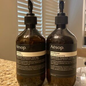 Two empty Aesop pump bottles